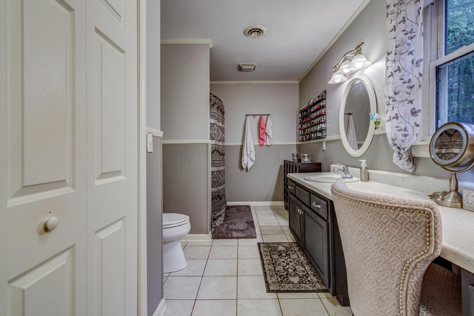 772 Skyview Road Salem, VA 24153 - Photo 28 of 41 a spacious bathroom with a granite countertop sink and a mirror