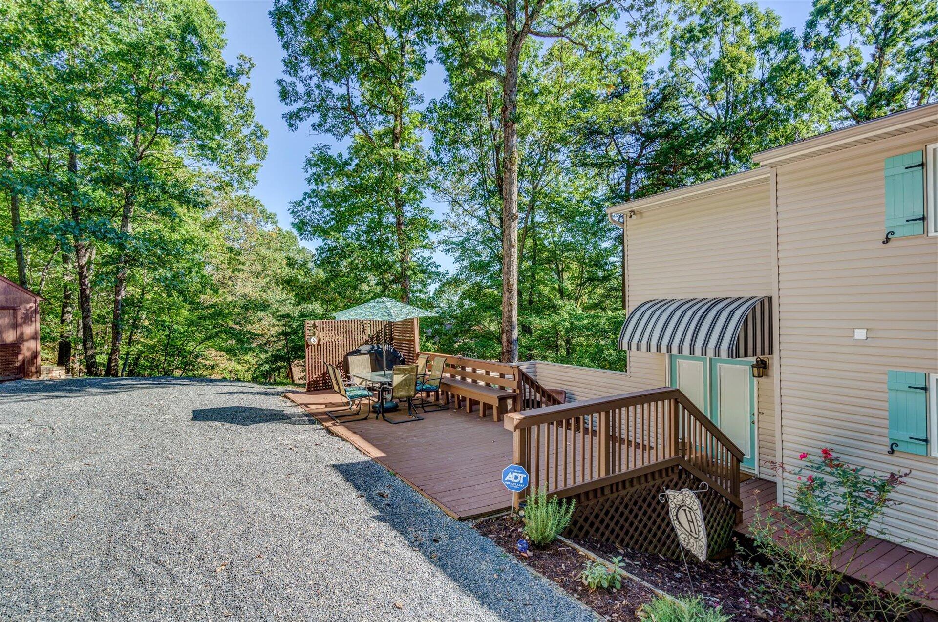 772 Skyview Road Salem, VA 24153 - Photo 31 of 41 a view of a wooden deck with chairs and a yard