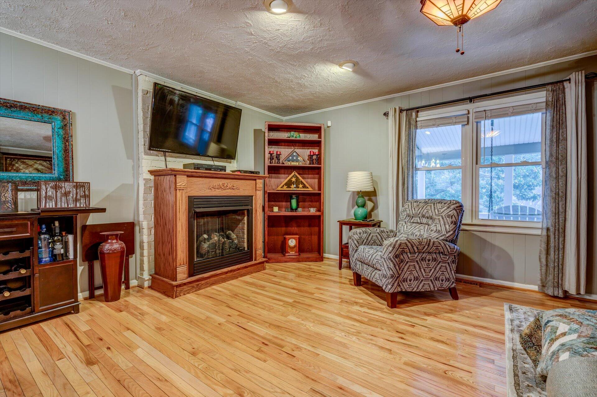 772 Skyview Road Salem, VA 24153 - Photo 8 of 41 a living room with furniture a flat screen tv and a fireplace