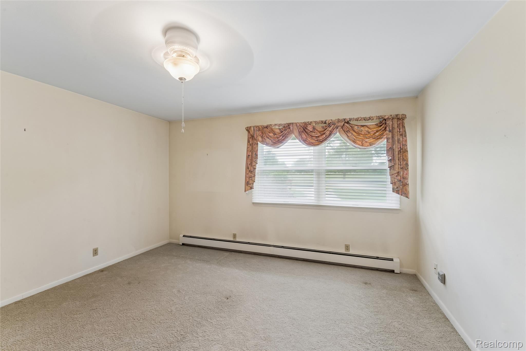 422 East Road Holly, MI 48442 - Photo 28 of 51 Carpeted room featuring a ceiling-mounted light fixture, a window with blinds and a valance, and baseboard heating