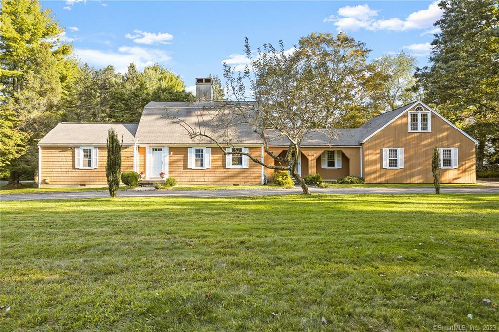 777 Cedar Road Fairfield, CT 06890 - Photo 1 of 1 a front view of a house with a garden