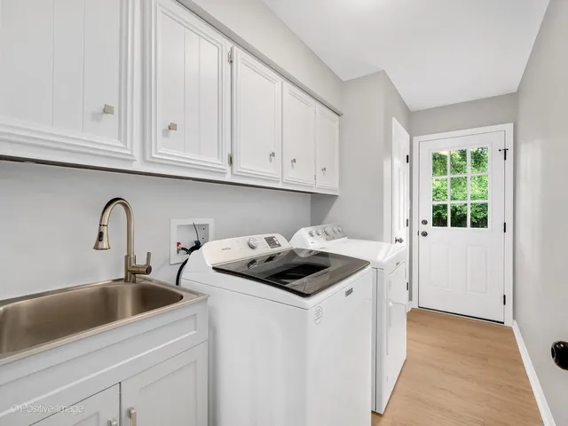 a kitchen with granite countertop white cabinets and sink