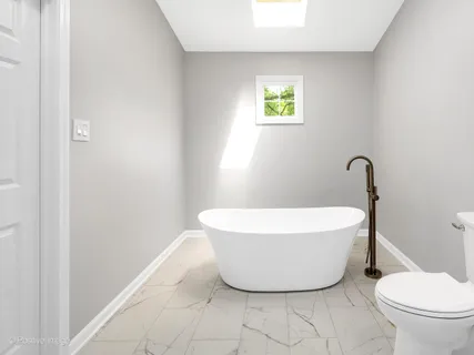 a white bath tub sitting next to a white toilet