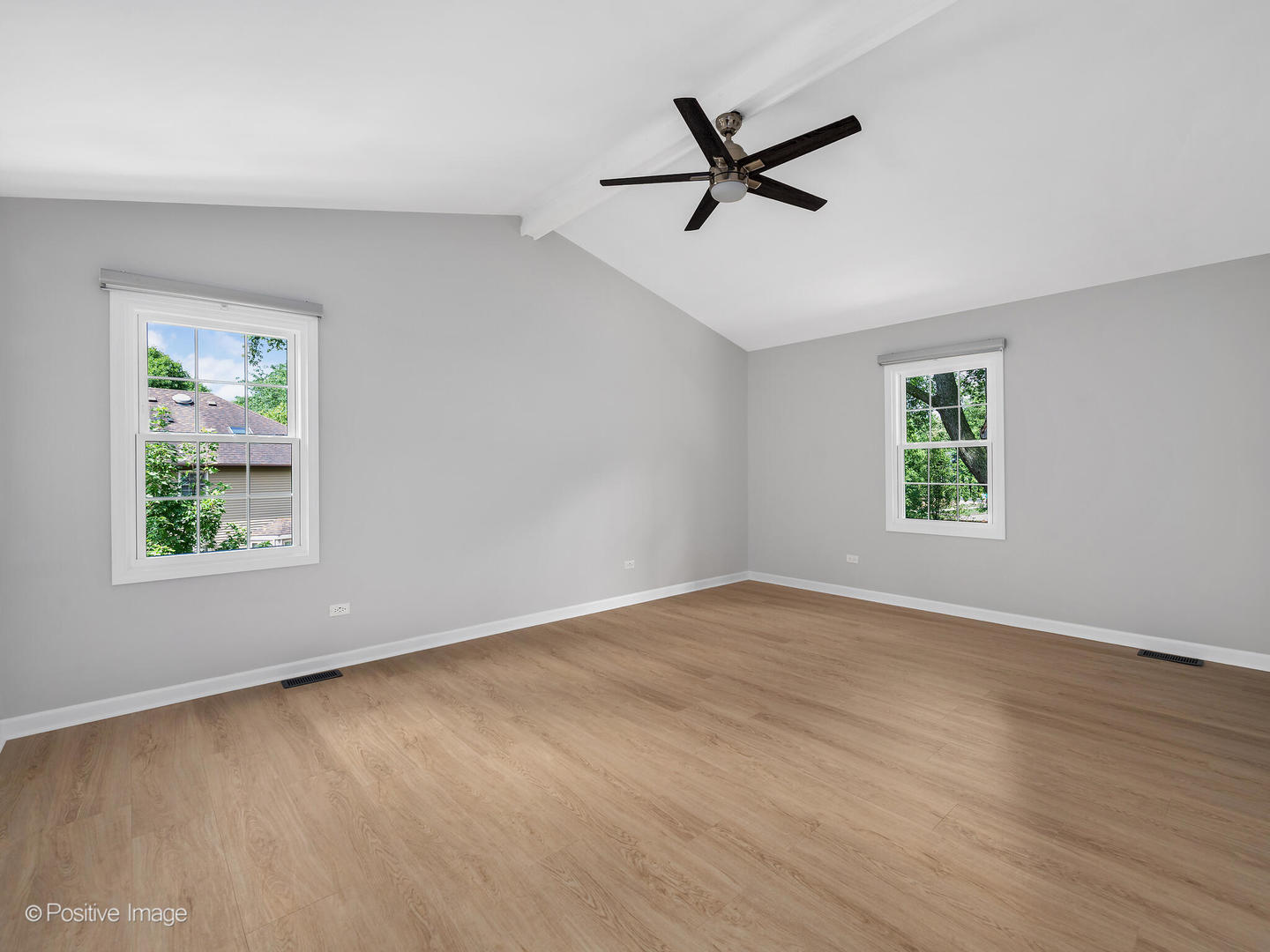 805 Potomac Avenue Naperville, IL 60565 - Photo 18 of 38 a view of a big room with wooden floor a ceiling fan and windows