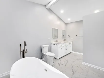 a bathroom with double vanity sink and mirror