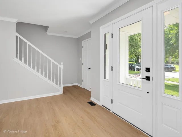 a view of an entryway with wooden floor and windows