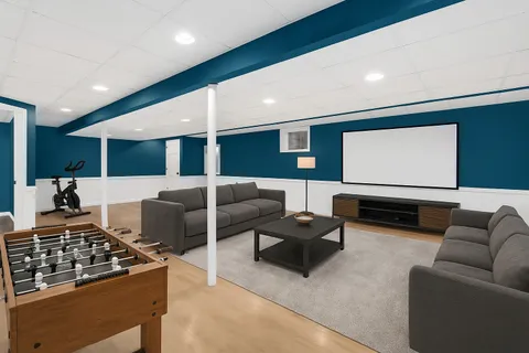 a living room with furniture and kitchen view