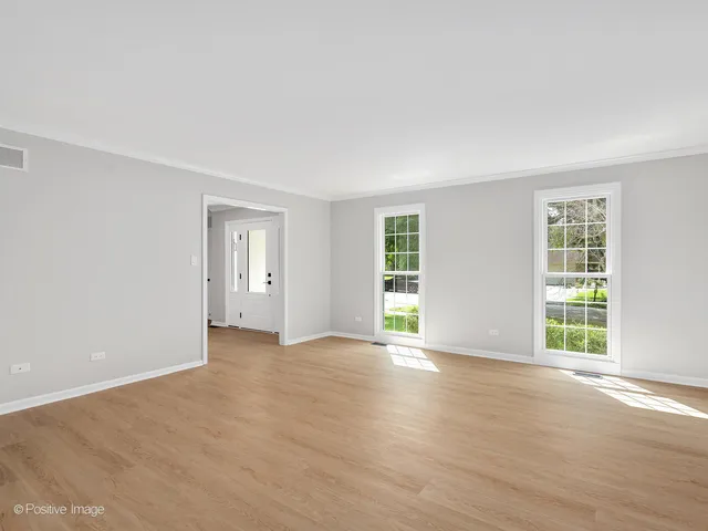 an empty room with windows and closet