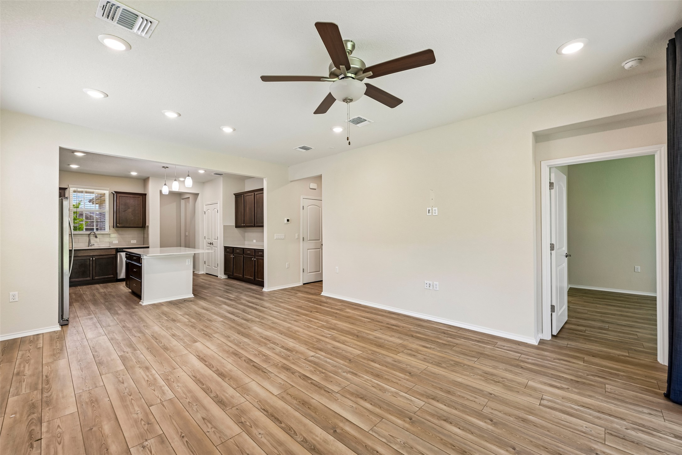 401 Yorktown Street Georgetown, TX 78633 - Photo 12 of 38 Open-concept living area featuring wood-finish flooring, recessed lighting, and a ceiling fan