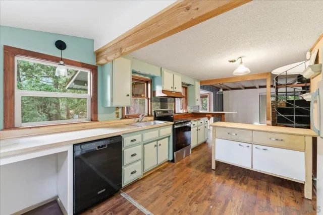 a kitchen with a stove a sink and a refrigerator