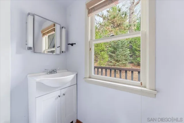 a view of a balcony with wooden floor and fence