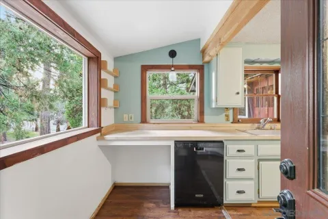 a kitchen with a sink and large window