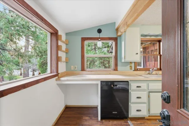 a kitchen with a sink and large window