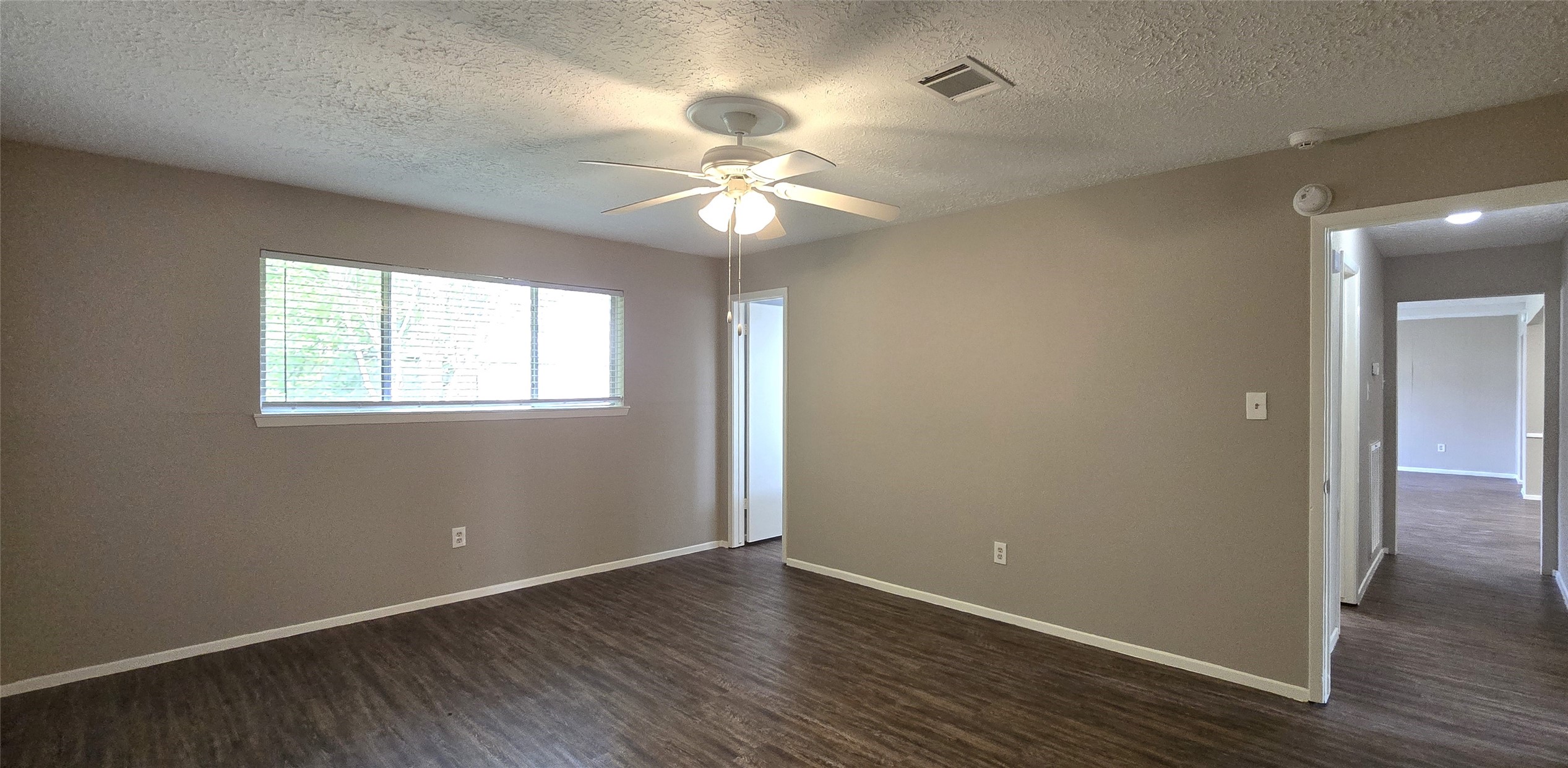 23019 Tree Bright Lane Spring, TX 77373 - Photo 15 of 20 Another view of primary bedroom. En-suite bath to the left. Hallway to living room on the right.