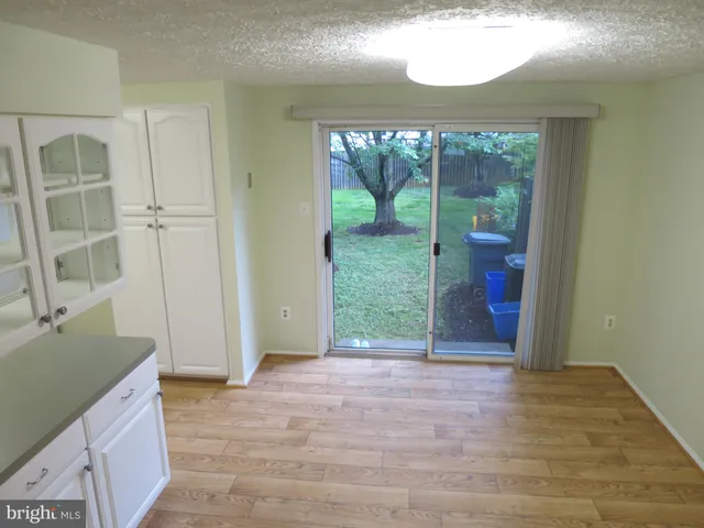 an empty room with entrance and windows