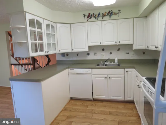a kitchen with stainless steel appliances granite countertop a sink and cabinets