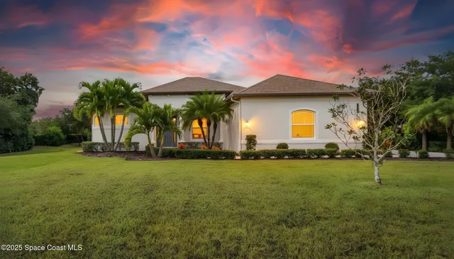 a front view of house with yard and outdoor seating