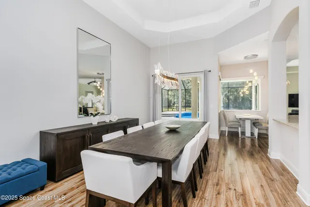 a view of a dining room with furniture and wooden floor