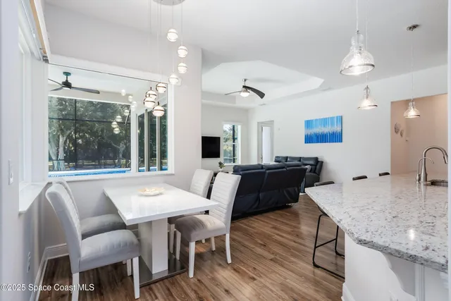 a kitchen with kitchen island granite countertop a stove and a sink