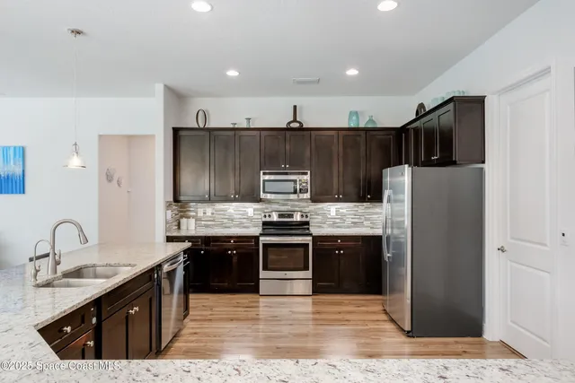 a large kitchen with a table and chairs