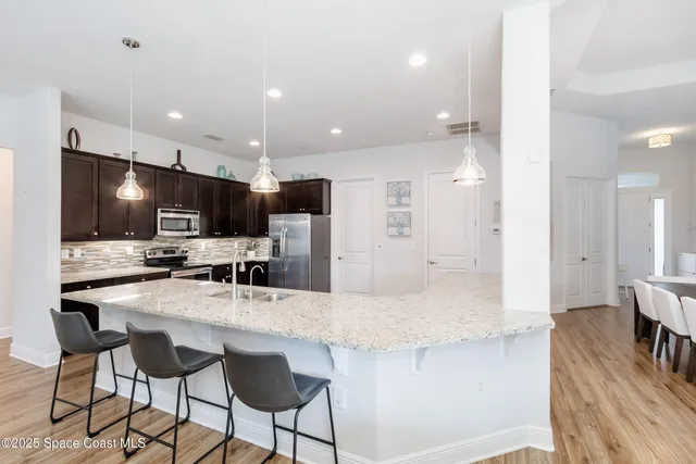 a large kitchen with a sink and cabinets