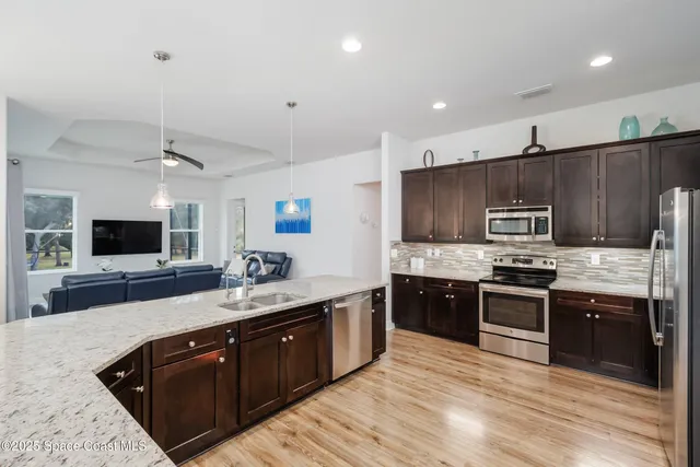 a kitchen with a sink stove and cabinets