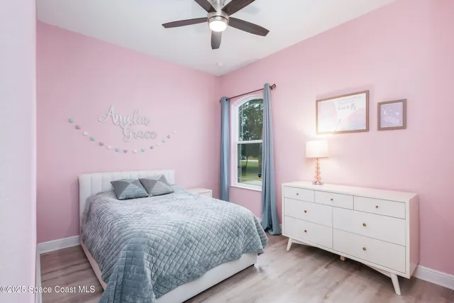 a bedroom with a bed and a mirror