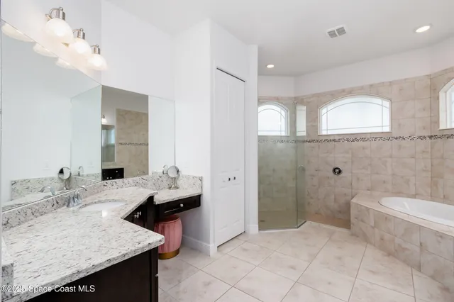 a bathroom with a granite countertop sink toilet a mirror and shower