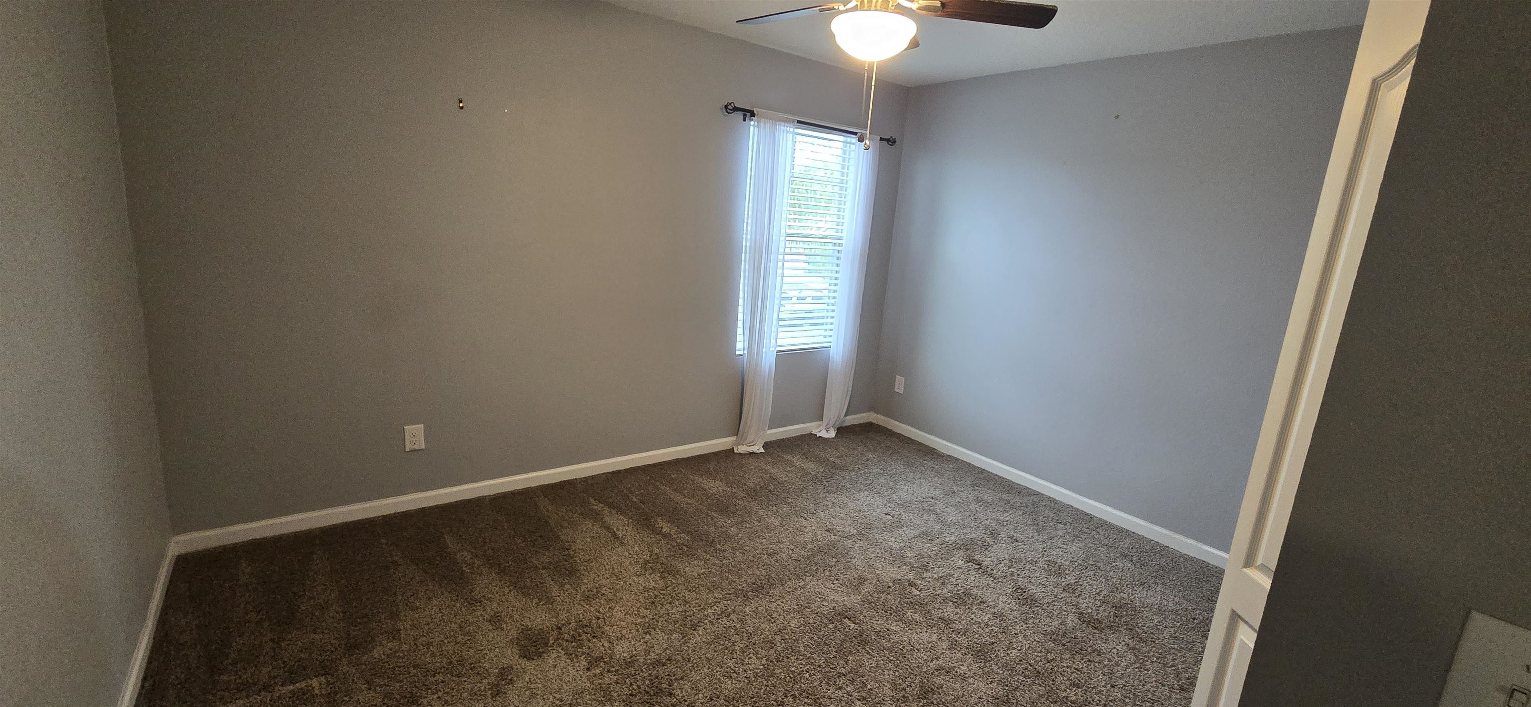 194 Ashby Lndg Way St. Augustine, FL 32086 - Photo 11 of 12 an empty room with windows and chandelier fan