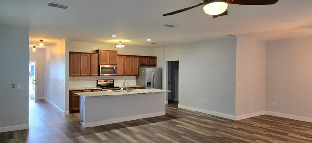 a kitchen with stainless steel appliances granite countertop a sink and cabinets