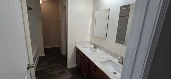 a bathroom with a granite countertop sink and a mirror
