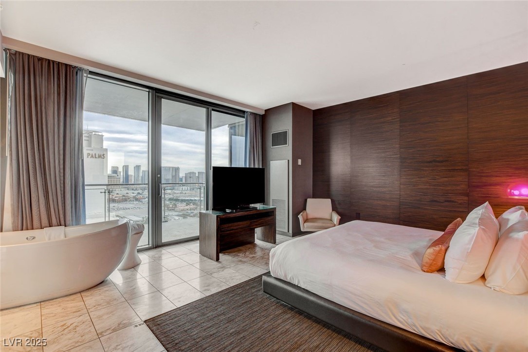 4381 West Flamingo Road, Unit 2202 Las Vegas, NV 89103 - Photo 19 of 40 Bedroom featuring floor to ceiling windows, access to exterior, and light marble finish floors