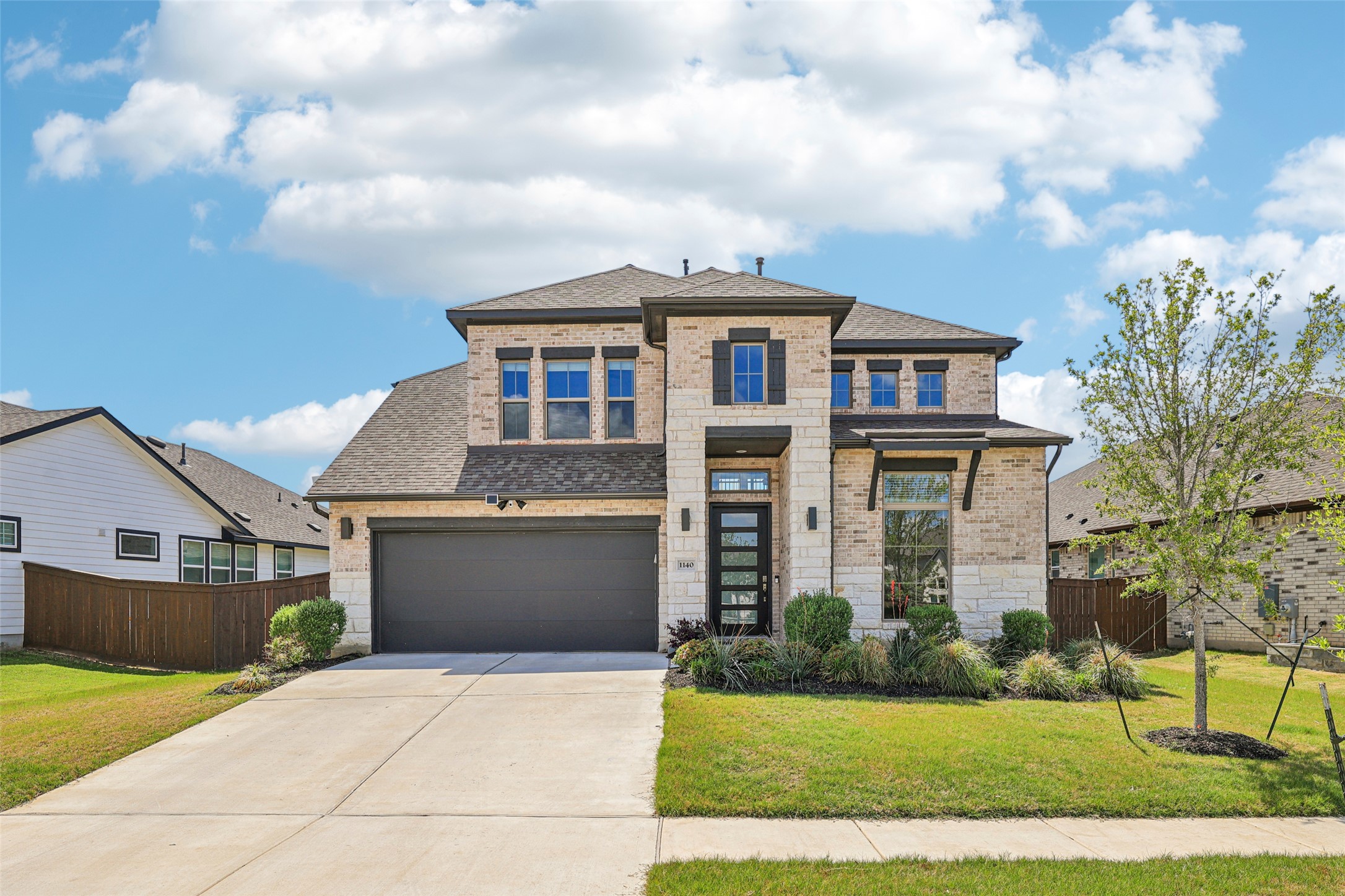 1140 Bryson Rdg Trail Leander, TX 78641 - Photo 1 of 39 A striking contemporary residence boasts an inviting brick and stone facade with tasteful landscaping.