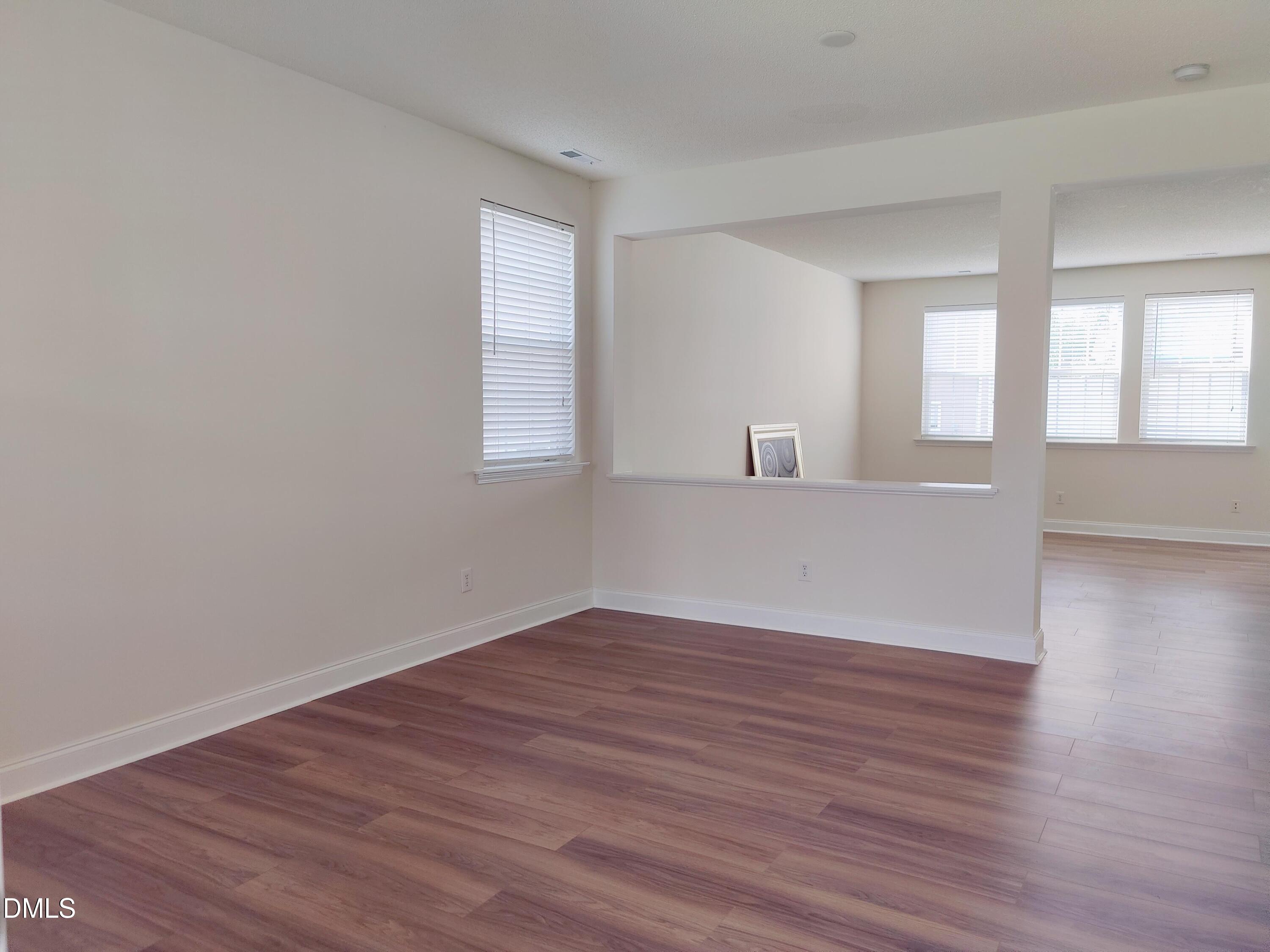 4011 Oatgrass Lane Raleigh, NC 27604 - Photo 5 of 21 wooden floor in an empty room with a window