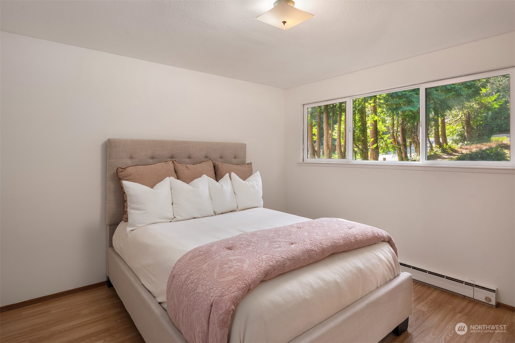 2631 Southwest Lake Roesiger Road Snohomish, WA 98290 - Photo 8 of 18 a large bed sitting in a bedroom next to a window