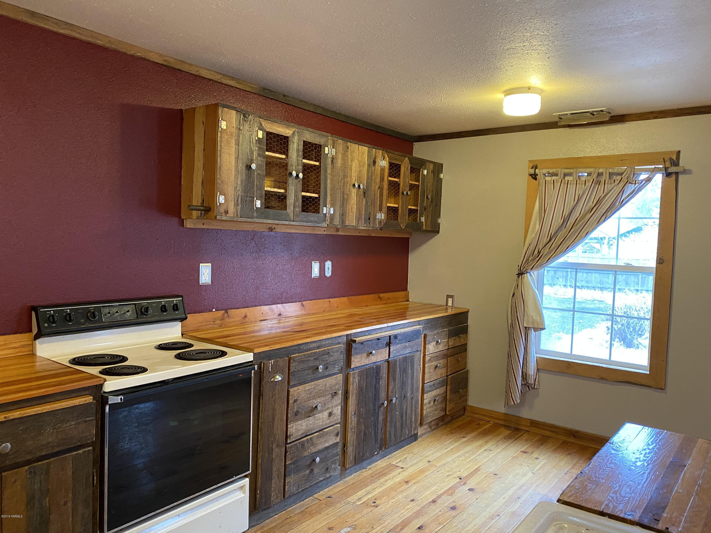 9161 South Naches Road Naches, WA 98937 - Photo 4 of 11 a kitchen with stainless steel appliances granite countertop a sink and a stove next to a window