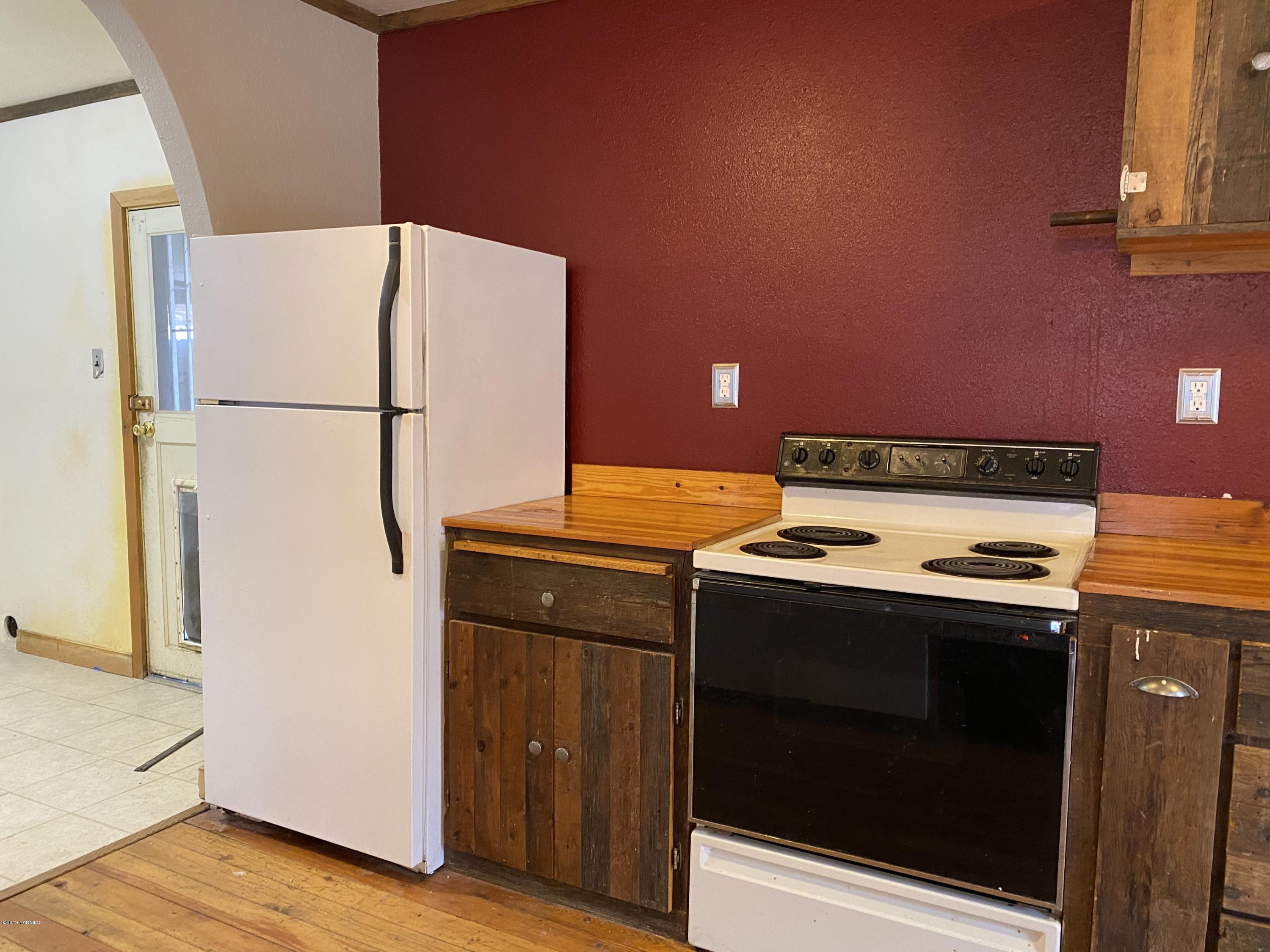 9161 South Naches Road Naches, WA 98937 - Photo 6 of 11 a kitchen with a stove top oven a refrigerator and a stove