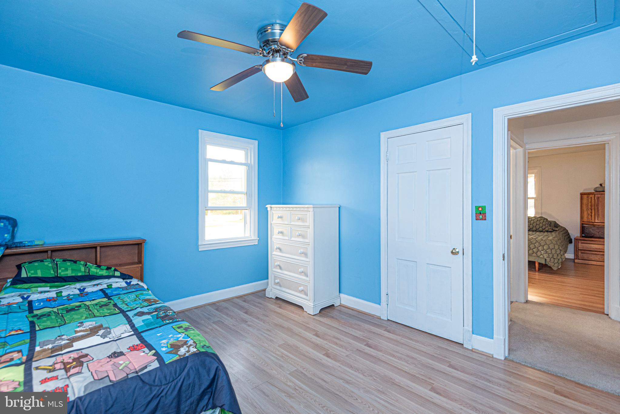 506 Park Avenue Ridgely, MD 21660 - Photo 30 of 59 a bedroom with a bed and a chandelier