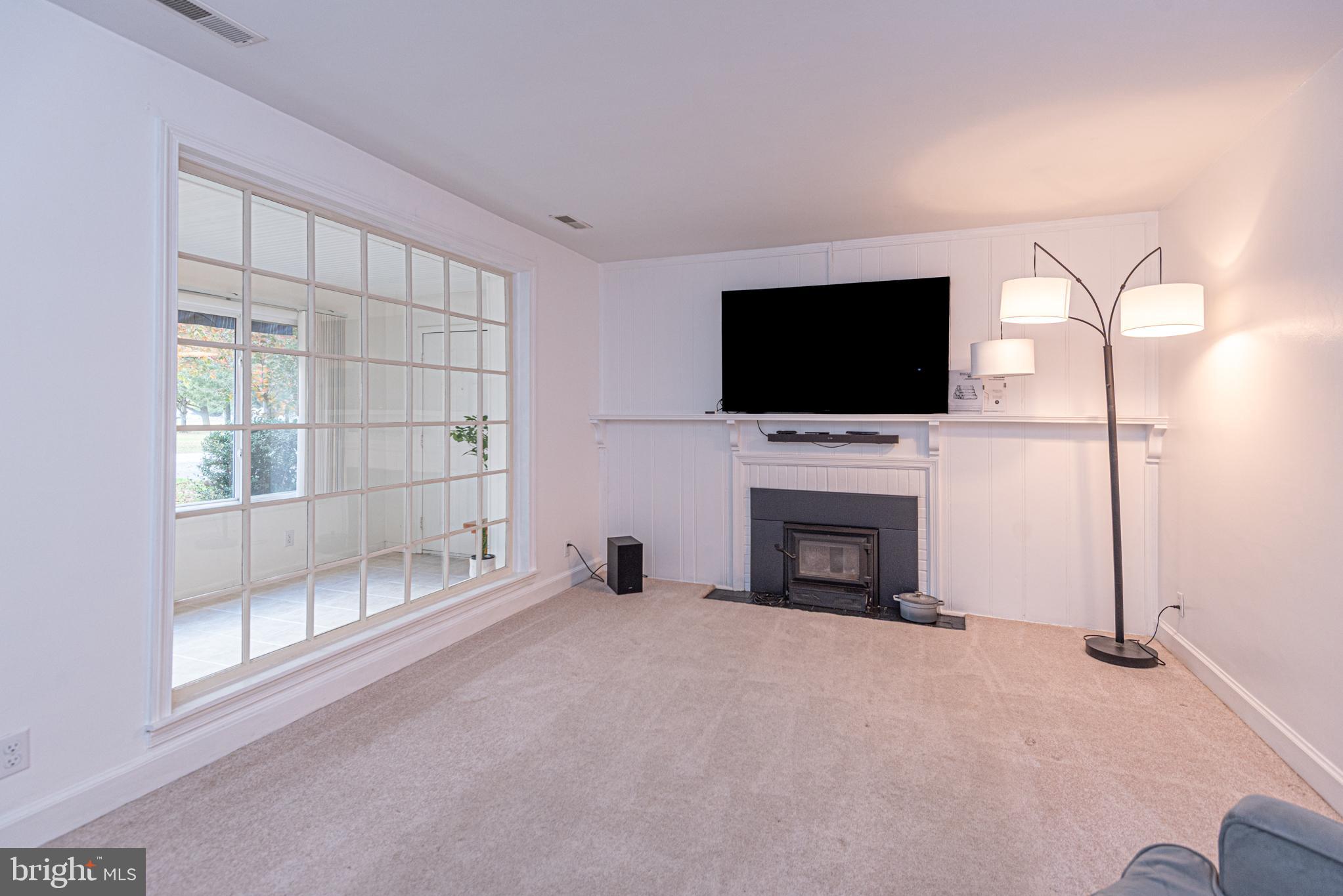506 Park Avenue Ridgely, MD 21660 - Photo 9 of 59 a living room with a fireplace and a flat screen tv