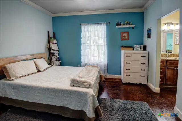 a bedroom with a bed and a dresser in it
