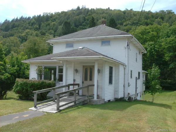 a front view of a house with a garden