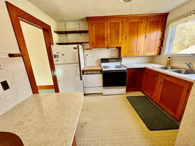 a view of a room with wooden floor and a window