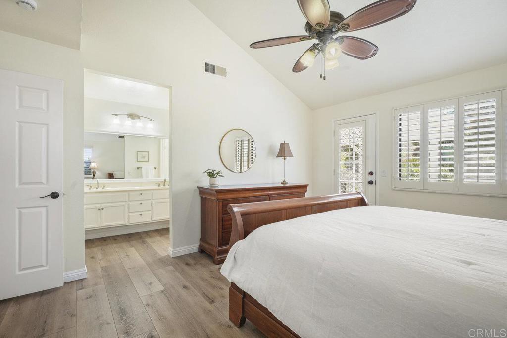 1729 Pinehurst Avenue Escondido, CA 92026 - Photo 20 of 29 a bedroom with a bed a dresser and potted plants