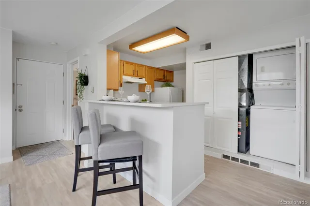 a dining room with furniture and a window