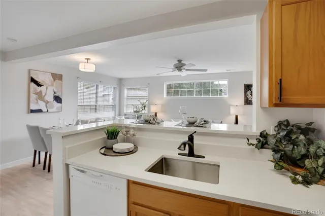 a kitchen with sink a stove and cabinets