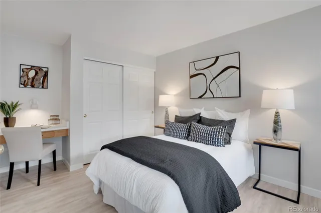 a bedroom with a bed and a lamp on table