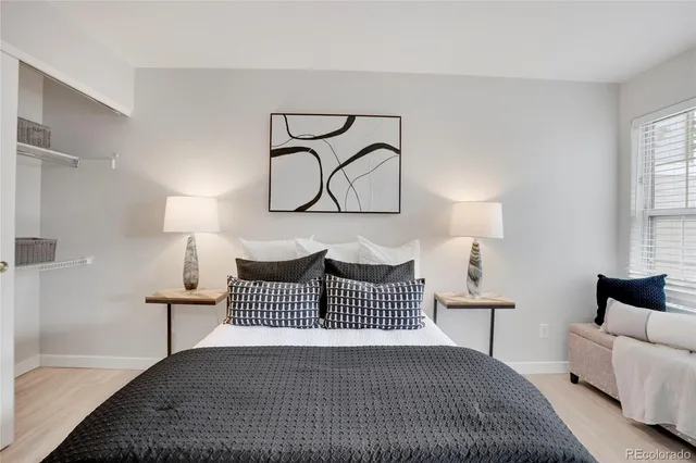 a bedroom with a bed and a night stand