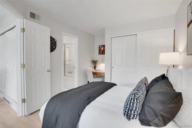 a bedroom with a bed and a lamp