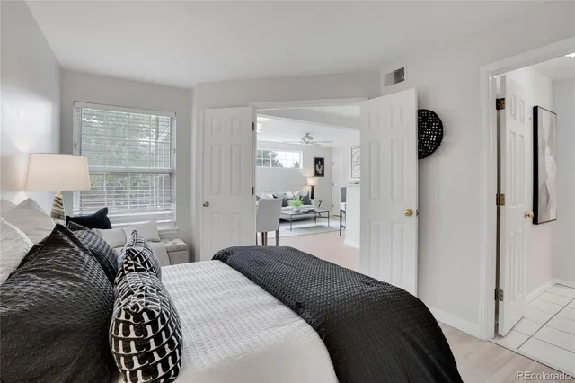 a bedroom with a bed and a lamp