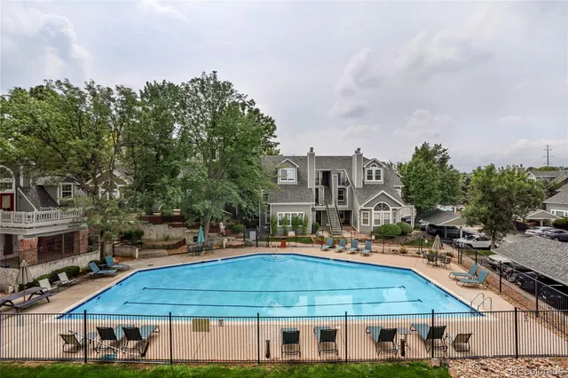 a aerial view of a houses with yard and trees